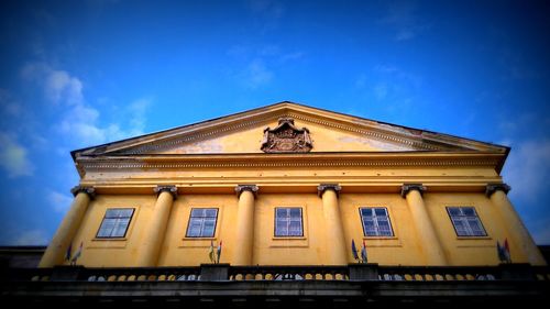 Low angle view of built structure against blue sky