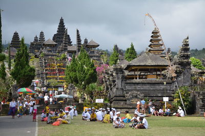 People at temple against sky