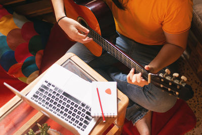 High angle view of man playing guitar