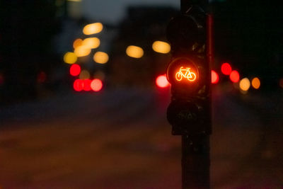 Close-up of illuminated road signal at night