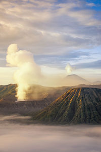 View of volcanic landscape against cloudy sky