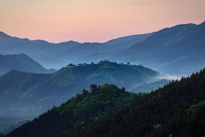 Scenic view of silhouette mountains against sky at sunset