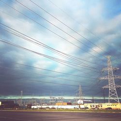 Low angle view of electricity pylon against sky