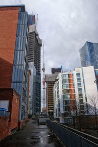 Street amidst buildings in city against sky