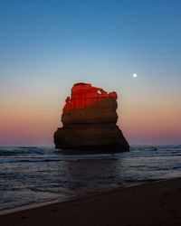 Scenic view of sea against clear sky during sunset