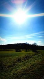 Scenic view of field against blue sky