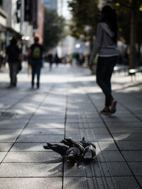 Close-up of people walking on street