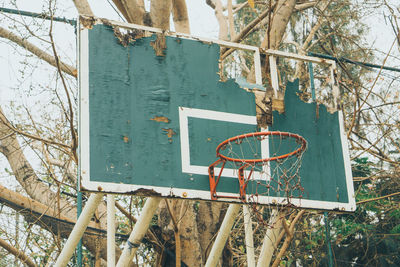 Low angle view of basketball hoop against trees