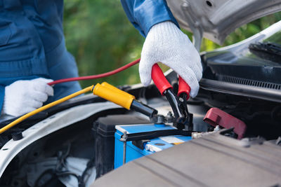 Low section of mechanic repairing car