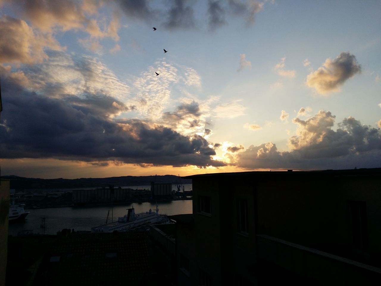 sunset, sky, silhouette, cloud - sky, built structure, bird, architecture, building exterior, cloud, animal themes, scenics, cloudy, beauty in nature, orange color, nature, dusk, tranquility, tranquil scene, outdoors, flying