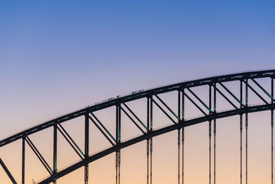 Low angle view of silhouette bridge against clear sky