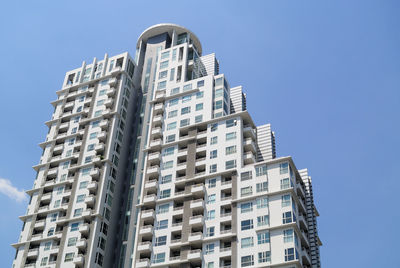 Low angle view of buildings against clear blue sky