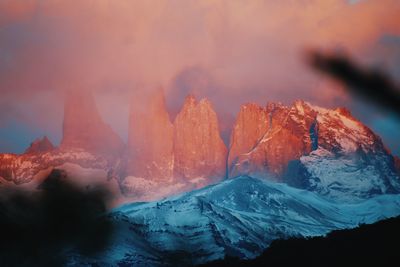 Scenic view of snowcapped mountains against sky during sunset