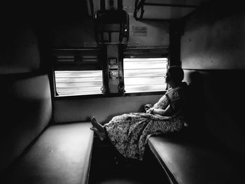 Side view of woman sitting in train