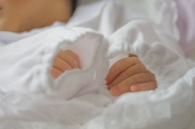 Close-up of baby lying on bed