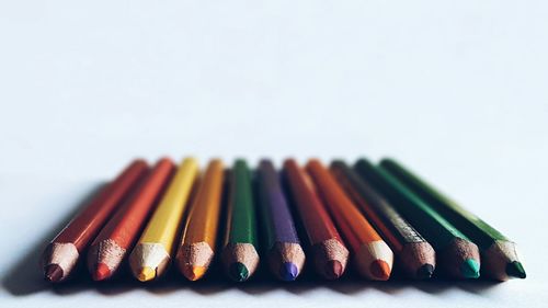 Close-up of colored pencils on white background