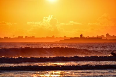 Scenic view of beach against sky during sunset