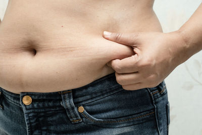 Midsection of shirtless man