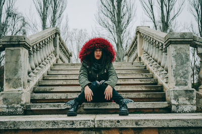 Portrait of woman sitting on staircase