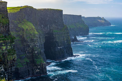 Scenic view of sea against rock formation