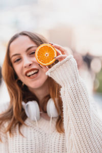 Portrait of a smiling young woman holding ice cream