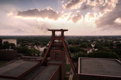 High angle view of illuminated building against sky during sunset