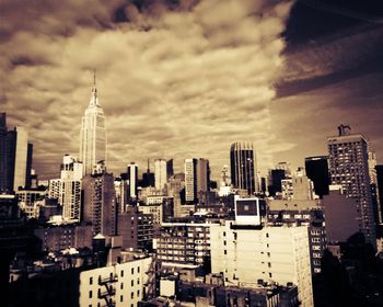 City skyline against cloudy sky