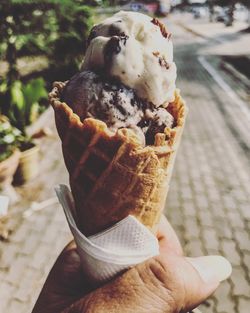 Close-up of hand holding ice cream cone