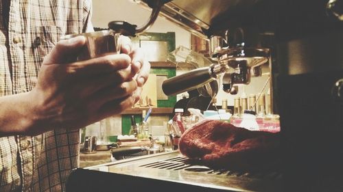 Close-up of man preparing food in cafe