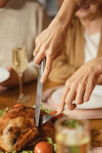 Midsection of woman preparing food on table