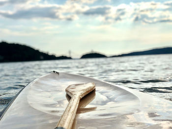 Close-up of wood in sea against sky