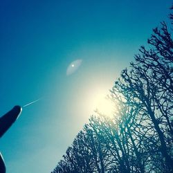 Low angle view of vapor trail against blue sky