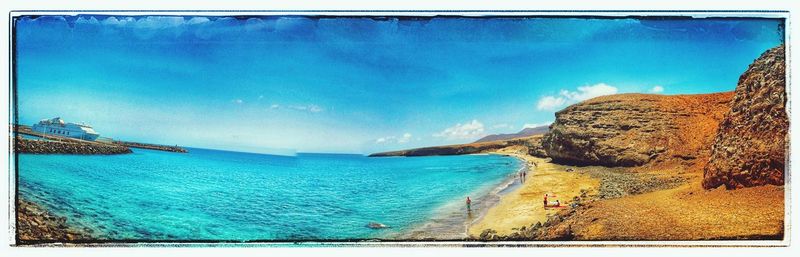 Panoramic view of sea against blue sky