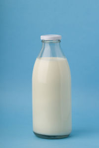 Close-up of blue bottle against white background