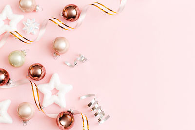 Christmas decoration on pastel pink background. new year. flat lay, top view, copy space.