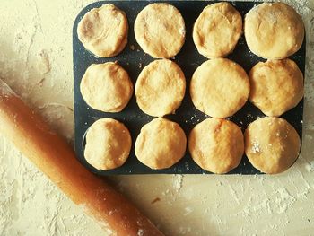 High angle view of rolling pin and mince pie preparation on table