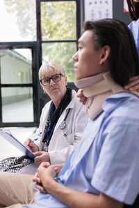 Female doctor examining patient in hospital