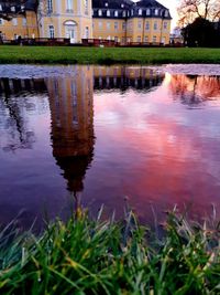 Reflection of buildings on lake in city