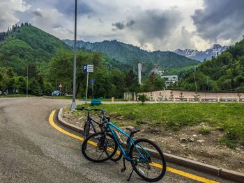 Bicycle by road against sky