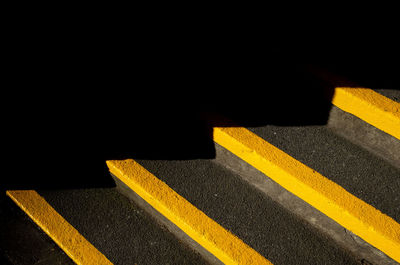 High angle view of yellow crossing sign on road