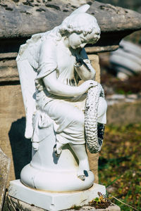 Close-up of buddha statue against temple