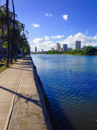 Calm sea with buildings in background