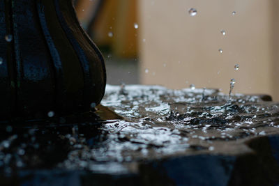 Close-up of wet glass on table