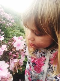 Close-up of girl smelling flowers