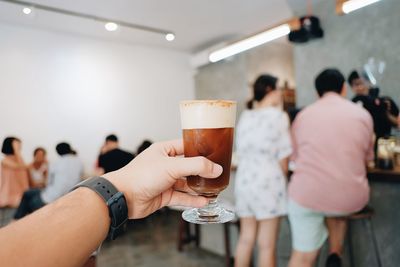 Midsection of people holding drink