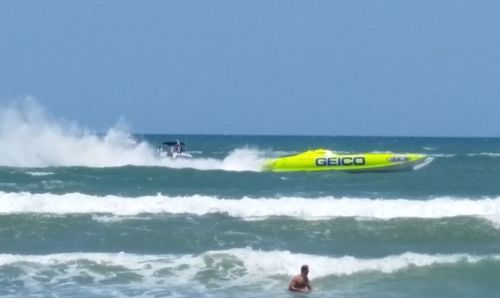 Man surfing in sea against sky