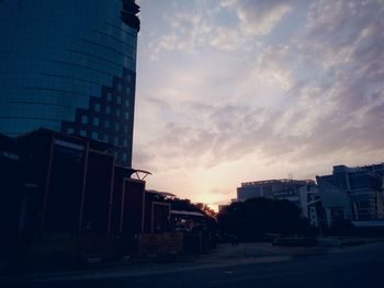 Buildings against sky at sunset