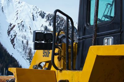 High angle view of snow covered mountain. in front you can see a bulldozer.