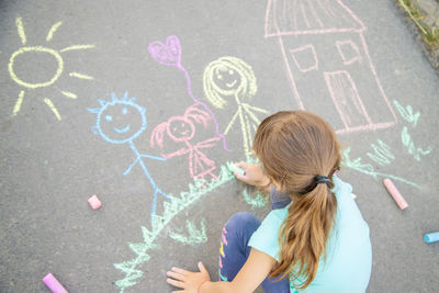 Girl drawing on road