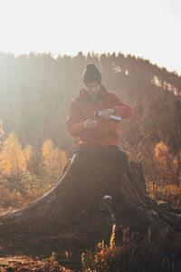 Rear view of man sitting on mountain